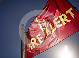 Close up of flag reading `Fire Alert` in yellow letters photo